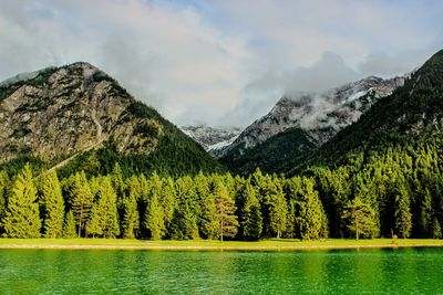 Scenic view of lake and mountains against sky