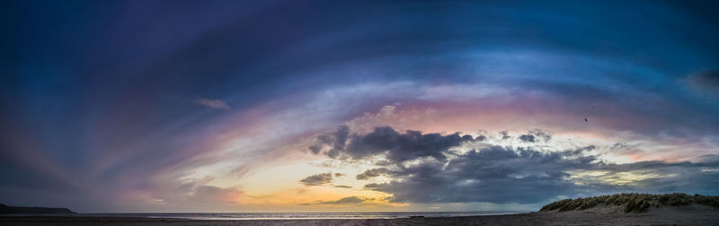 Scenic view of sea against dramatic sky