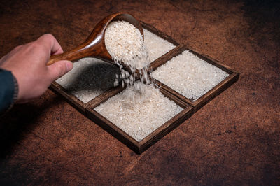 Cropped image of hand holding key ring on table