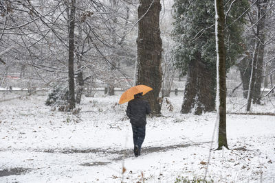 Full length of woman walking in snow during winter