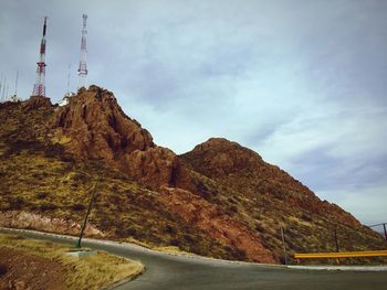 Road by mountain against sky