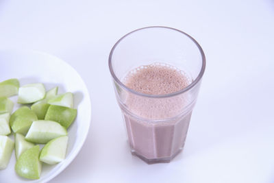 High angle view of drink in glass over white background