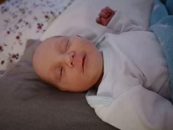 High angle view of baby sleeping on bed