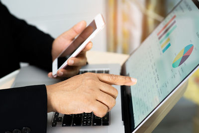 Midsection of man using smart phone