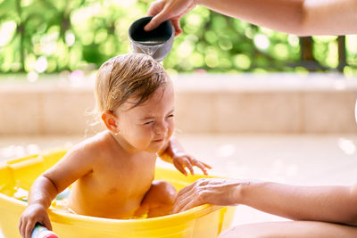 Mother bathing daughter