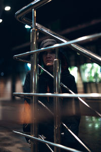 Woman wearing hooded jacket looking away