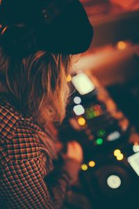 Close-up of woman with illuminated lights at night