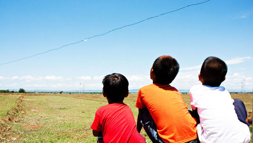 Rear view of children overlooking landscape