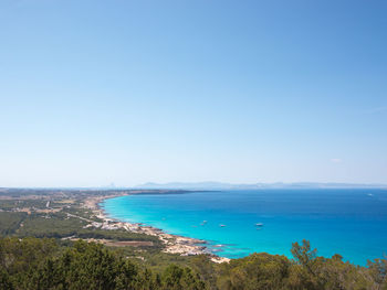 Scenic view of sea against clear blue sky