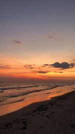 Scenic view of beach against sky during sunset