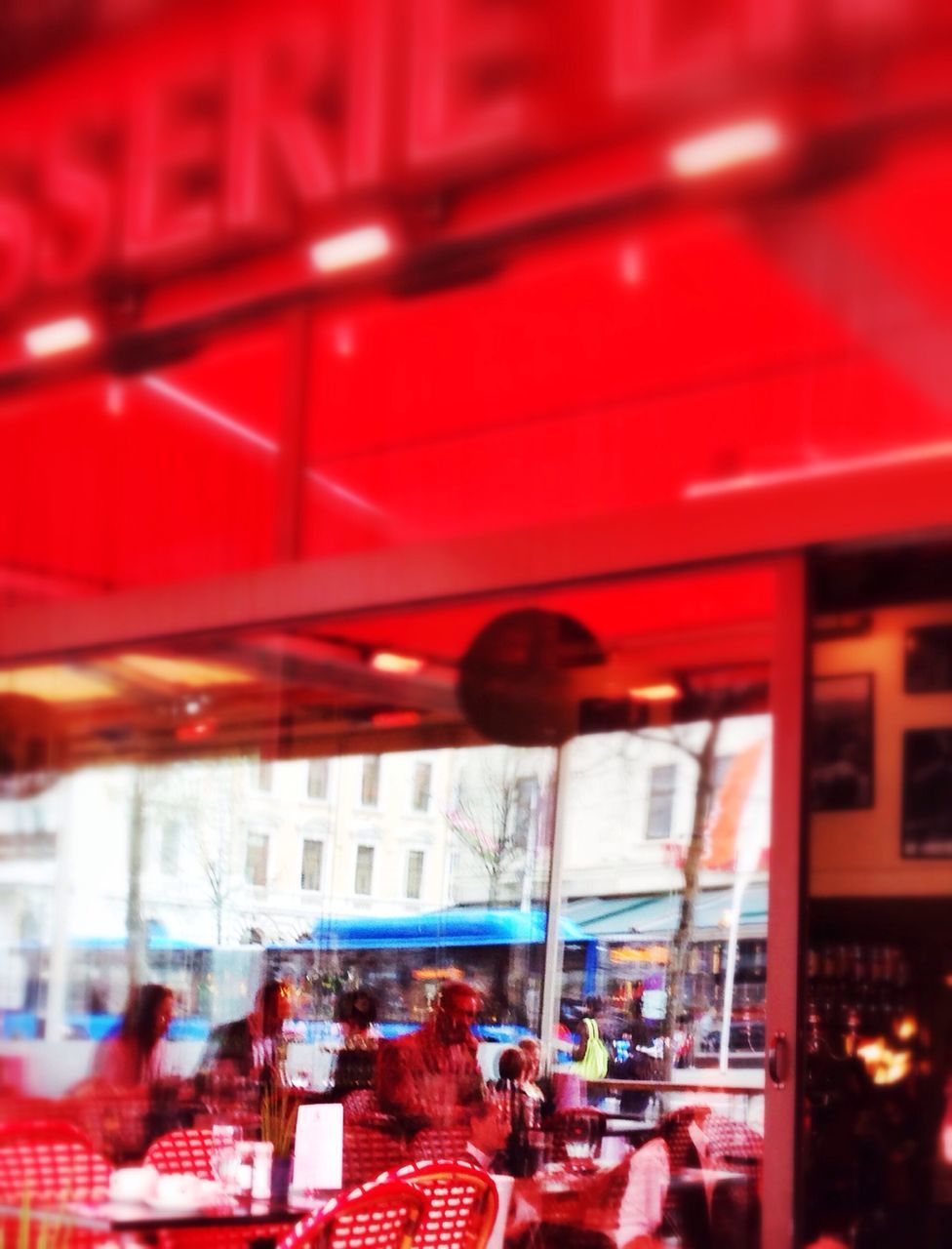 red, built structure, architecture, indoors, building exterior, window, day, in a row, hanging, illuminated, incidental people, city, focus on foreground, selective focus, railing, chair, building, lighting equipment