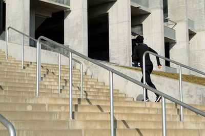 Low angle view of man walking on stairs