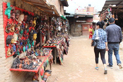 Rear view of people at market stall in city