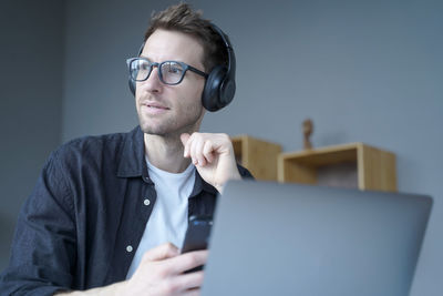 Businessman looking way while sitting at office