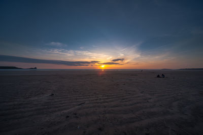 Scenic view of beach against sky during sunset