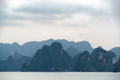 Scenic view of mountains in halong bay against sky