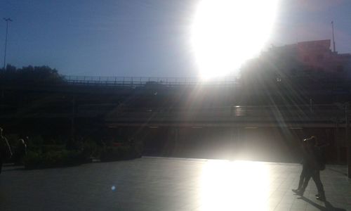 Man in sunlight against sky