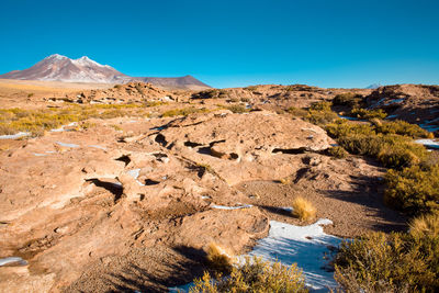 Scenic view of rocky mountains against clear blue sky