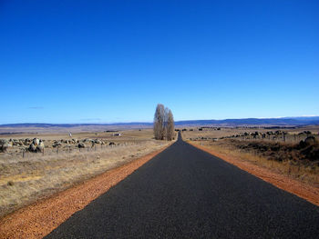 Scenic view of road against clear blue sky