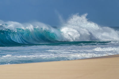 Scenic view of sea waves against sky