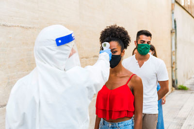 People standing against wall