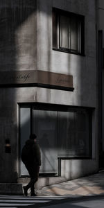 Rear view of woman standing in abandoned building