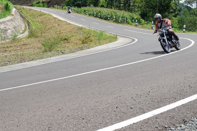 Man riding bicycle on road