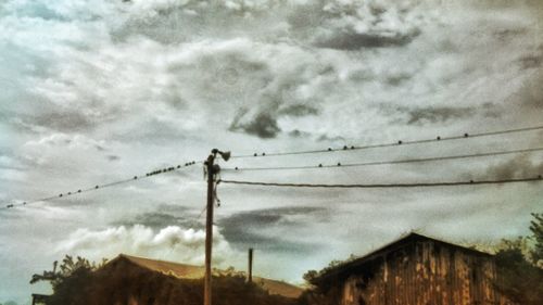 High section of house against cloudy sky