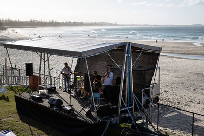 People on beach against sky