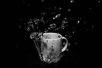 Close-up of coffee cup against black background