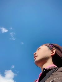 Portrait of young man looking away against sky