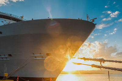 Low angle view of nautical vessel against sky during sunset