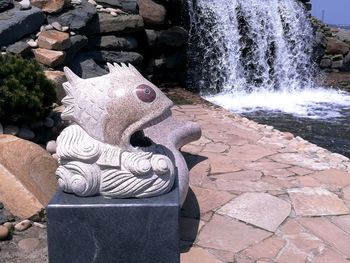 View of fountain against stone wall