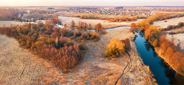 High angle view of river amidst city against sky