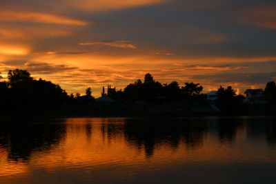 Scenic view of lake against orange sky