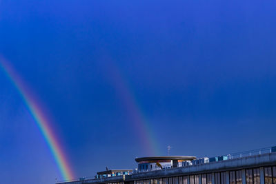 Low angle view of rainbow bridge against blue sky