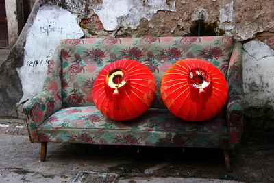 Chinese lanterns on sofa against abandoned wall