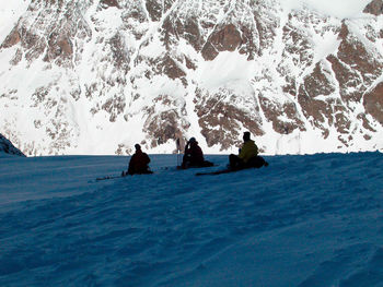 People on snowcapped mountain during winter