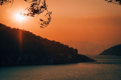 Scenic view of sea against orange sky