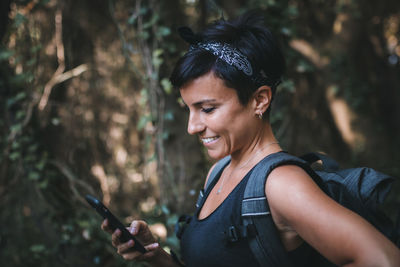 Portrait of smiling young woman holding camera