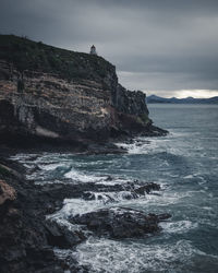 Rock formations in sea against sky