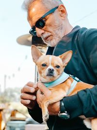 Portrait of man holding dog