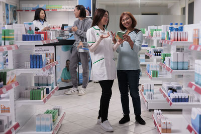 Portrait of female friends standing in laboratory