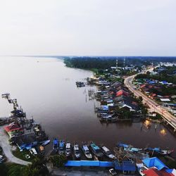 High angle view of harbor by buildings in city