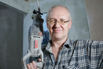 Portrait of man standing in workshop