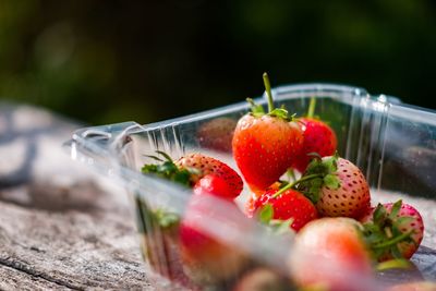 Close-up of strawberries on glass table