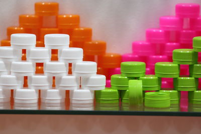 Close-up of bottle caps on shelf