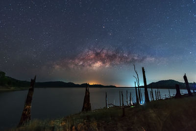 Scenic view of lake against sky at night