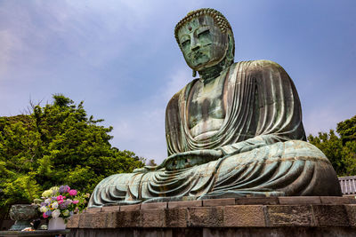 Low angle view of statue against sky