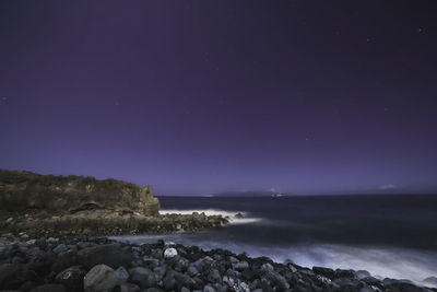 Scenic view of sea against sky at night